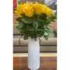 Solid white vase featuring yellow roses
